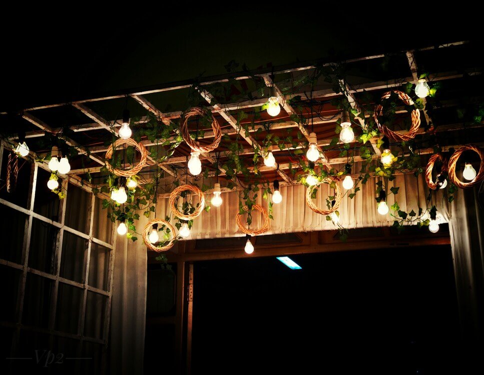Guirnaldas de luz iluminan un jardín preparado para la noche
